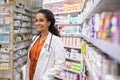 Mixed race happy pharmacist in medical shop