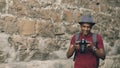 Mixed race happy tourist man taking photo on his dslr camera standing near famous building in Europe Royalty Free Stock Photo