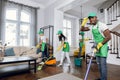 Mixed race janitors doing spring cleaning of house Royalty Free Stock Photo