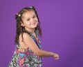 Mixed race little girl dancing on purple