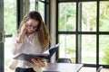 Mixed-race long hair nerd woman in casual dress looking at some Royalty Free Stock Photo