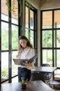 Mixed-race long hair nerd woman in casual dress looking at some Royalty Free Stock Photo