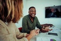 Mixed race male business man happy with improvements in ideas presented by colleagues sitting around table during Royalty Free Stock Photo