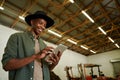 Mixed race male farmer typing on digital tablet standing in farm dairy Royalty Free Stock Photo