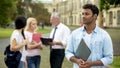 Mixed-race male student looking into distance, higher education and future