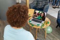 Mixed race man at bar making st patrick\'s day video call to female friend smiling on laptop