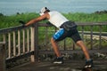 Mixed race man stretching