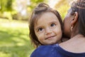 Mixed race mother holding her daughter, over shoulder view Royalty Free Stock Photo