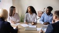 Mixed race motivated international coworkers discussing project. Royalty Free Stock Photo