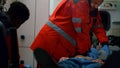 Mixed race paramedics providing heart massage to patient in ambulance car Royalty Free Stock Photo