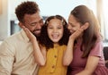 Mixed race parents enjoying weekend with daughter in home living room. Smiling hispanic girl hugging and bonding with Royalty Free Stock Photo