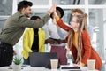 Mixed race people giving high five after successful meeting Royalty Free Stock Photo