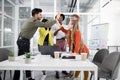 Mixed race people giving high five after successful meeting in modern office Royalty Free Stock Photo