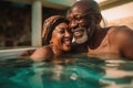 Mixed race middle age couple enjoying time in pool