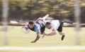 Mixed race rugby player diving to score a try during a rugby match outside on a field. Hispanic male athlete making a Royalty Free Stock Photo