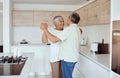 Mixed race senior couple dancing together in the morning at home. Smiling elderly husband and wife holding each other Royalty Free Stock Photo