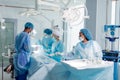 Mixed race technicians, anesthetists carry out surgery