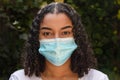 Mixed Race Teenager Girl Woman Wearing Coronavirus COVID-19 Face Mask