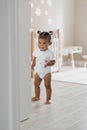 Mixed race toddler girl walking at room Royalty Free Stock Photo