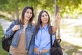 Mixed Race Twin Sisters Wearing Backpacks and Pointing Outside Royalty Free Stock Photo