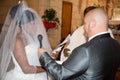 Mixed race wedding caucasian man and black woman interracial couple exchanging rings at ceremony church