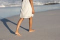 Mixed race woman bare feet touching the sand on beach on a sunny day Royalty Free Stock Photo