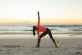 Mixed race woman on beach practicing yoga during sunset Royalty Free Stock Photo