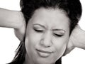 Mixed race woman closing ears with hands. Royalty Free Stock Photo