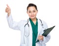 Mixed race woman doctor hold clipboard and thumb up Royalty Free Stock Photo