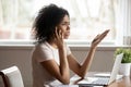 Mixed race woman having difficult conversation by mobile phone