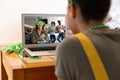 Mixed race woman making st patrick's day video call to smiling female friend on laptop at home Royalty Free Stock Photo