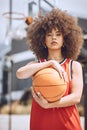 Mixed race woman posing on a basketball court. Beautiful basketball player posing confidently outside Royalty Free Stock Photo