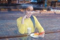 Mixed race woman sitting in a coffee shop with her latte drink Royalty Free Stock Photo