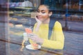 Mixed race woman sitting in a coffee shop with her latte drink Royalty Free Stock Photo