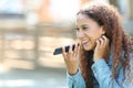 Mixed-race woman using voice recognition on phone