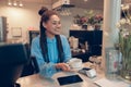 Mixed-race young beautiful female barista handing cup of coffee to customer. Bartender work. Royalty Free Stock Photo