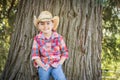 Cute Mixed Race Young Boy Wearing Cowboy Hat Standing Outdoors. Royalty Free Stock Photo