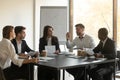 Mixed race young business employees team listening to leader. Royalty Free Stock Photo