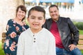 Mixed Race Young Couple Behind their Son on a Park Bench Royalty Free Stock Photo