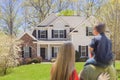 Mixed Race Young Family Looking At Beautiful Home Royalty Free Stock Photo