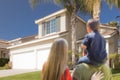 Mixed Race Young Family Looking At Beautiful Home Royalty Free Stock Photo