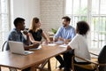 Mixed race young teammates discussing project details at brainstorming meeting. Royalty Free Stock Photo