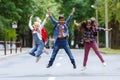 Mixed Racial Group happy children jumping in the park near school. Primary education concept.