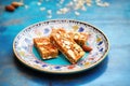 mixed raw nut bars on blue ceramic dish Royalty Free Stock Photo