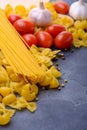 Mixed raw pasta and ingredients for cooking pasta Royalty Free Stock Photo