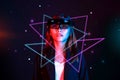 Mixed reality girl wearing hololens glasses under neon light on sparkling galaxy background. Virtual reality combine augmented