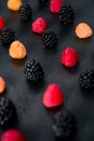 Mixed of red, black, yellow raspberries on table. Close up. Royalty Free Stock Photo