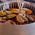 Mixed Roasted Meat and Seafood and Chopsticks on the BBQ Grill o Royalty Free Stock Photo