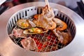 Mixed Roasted Meat and Seafood and Chopsticks on the BBQ Grill o Royalty Free Stock Photo