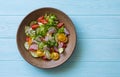 Mixed salad leaves, red and yellow tomatoes, cucumber and red onions salad in rustic plate Royalty Free Stock Photo
